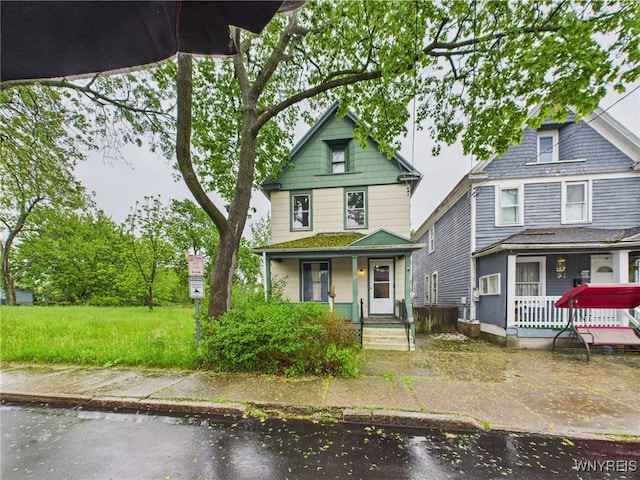 1307 Michigan Ave, Niagara Falls, NY 14305 - american foursquare style home featuring a porch