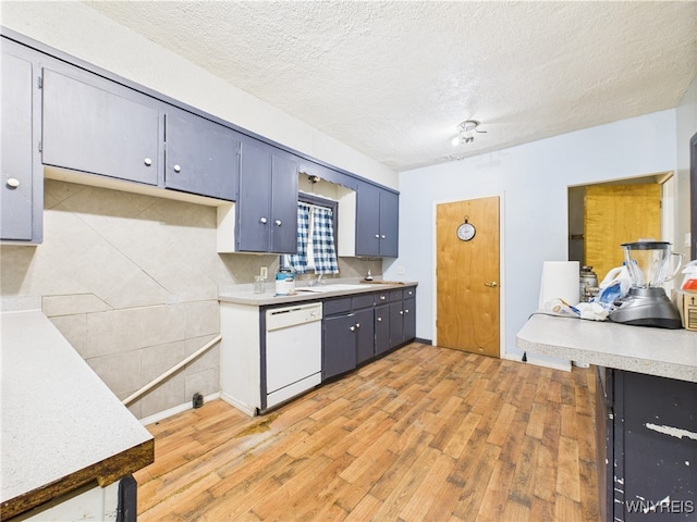 1307 Michigan Ave, Niagara Falls, NY 14305 - kitchen featuring white dishwasher, light wood-style floors, light countertops, a textured ceiling, and a sink