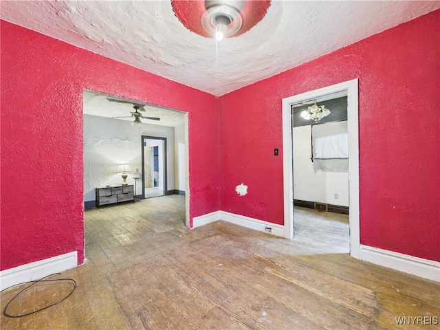 1307 Michigan Ave, Niagara Falls, NY 14305 - spare room featuring a textured wall, a ceiling fan, hardwood / wood-style floors, a textured ceiling, and baseboards