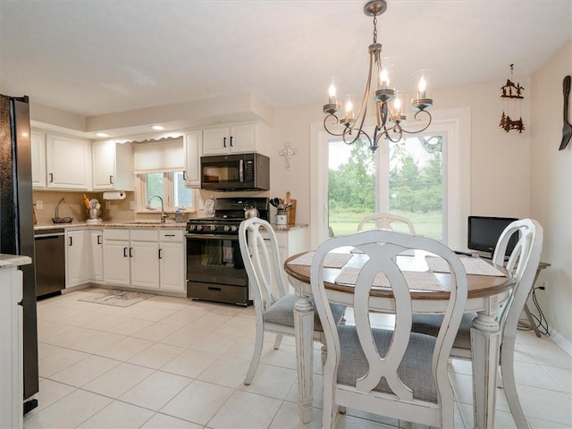 39 Sahara Dr, Gates, NY 14624 - dining area with a chandelier, light tile patterned floors, and baseboards
