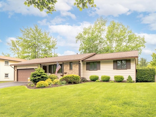 39 Sahara Dr, Gates, NY 14624 - view of front of house featuring asphalt driveway, a garage, and a front yard
