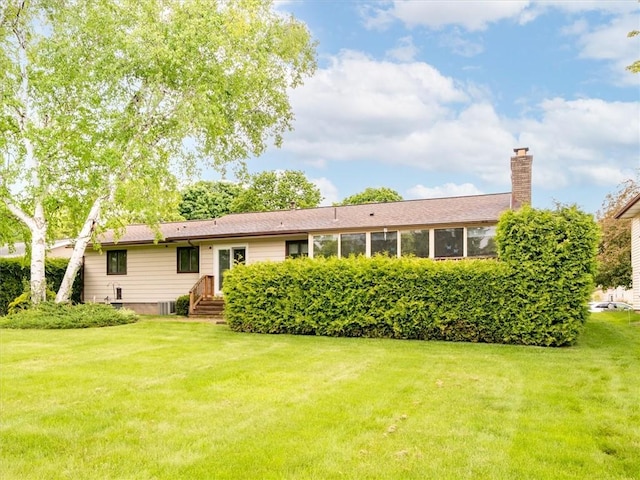 39 Sahara Dr, Gates, NY 14624 - rear view of property featuring a yard and a chimney