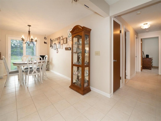 39 Sahara Dr, Gates, NY 14624 - dining space featuring a chandelier, light tile patterned floors, and baseboards