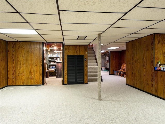 39 Sahara Dr, Gates, NY 14624 - finished below grade area featuring stairs, carpet flooring, wood walls, and a drop ceiling