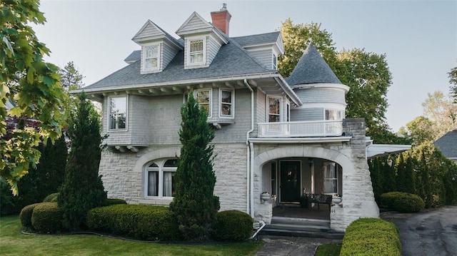 44 Riverside Dr, Binghamton-City, NY 13905 - view of front of house featuring a balcony, a porch, stone siding, a chimney, and roof with shingles
