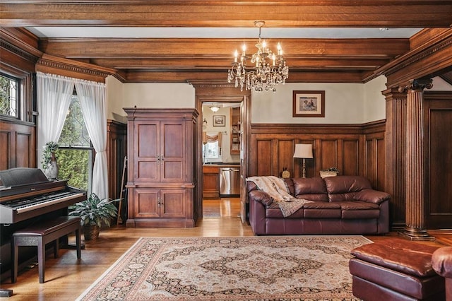 44 Riverside Dr, Binghamton-City, NY 13905 - living area featuring a chandelier, beam ceiling, light wood-style flooring, and wooden walls