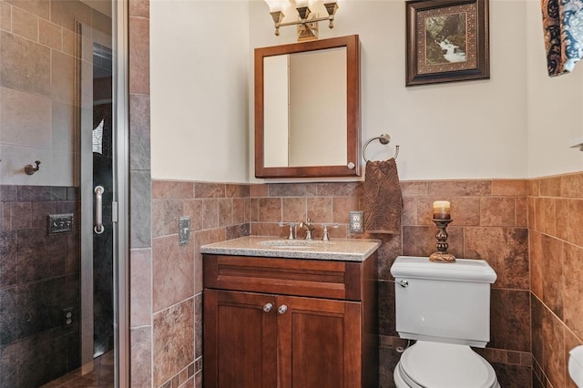 44 Riverside Dr, Binghamton-City, NY 13905 - bathroom featuring tile walls, toilet, vanity, a stall shower, and wainscoting