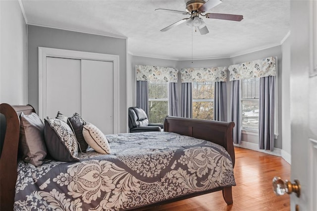 44 Riverside Dr, Binghamton-City, NY 13905 - bedroom featuring ornamental molding, wood finished floors, a closet, baseboards, and ceiling fan