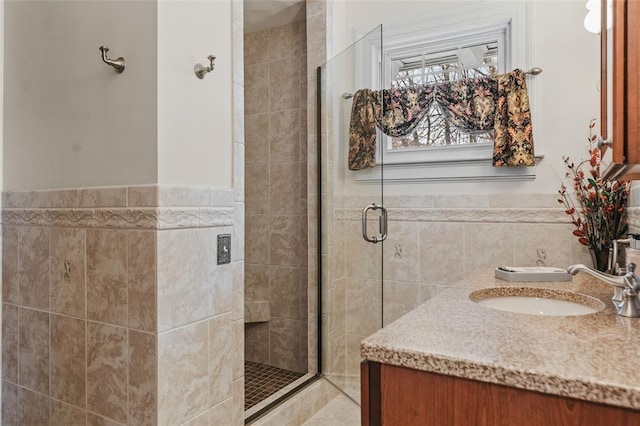 44 Riverside Dr, Binghamton-City, NY 13905 - full bath with tile walls, a shower stall, double vanity, and a wainscoted wall