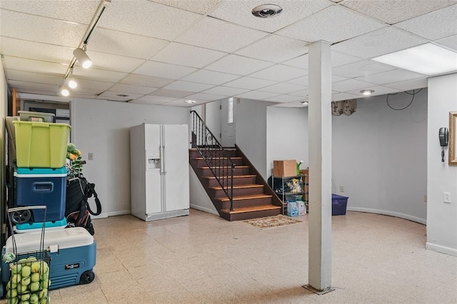 44 Riverside Dr, Binghamton-City, NY 13905 - finished below grade area with white fridge with ice dispenser, baseboards, rail lighting, tile patterned floors, and stairway