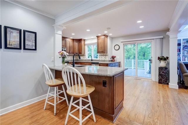 18 Chesham Way, Perinton, NY 14450 - kitchen with ornate columns, a peninsula, a breakfast bar, light wood-type flooring, and recessed lighting