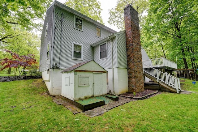 18 Chesham Way, Perinton, NY 14450 - back of house with a chimney, stairs, a lawn, and a deck