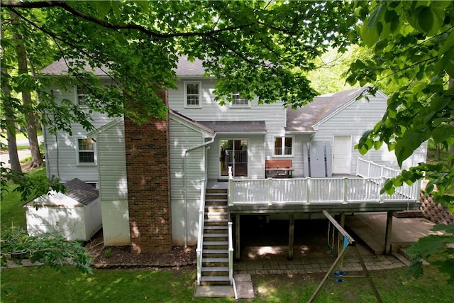 18 Chesham Way, Perinton, NY 14450 - rear view of property featuring stairway, a deck, and a shingled roof