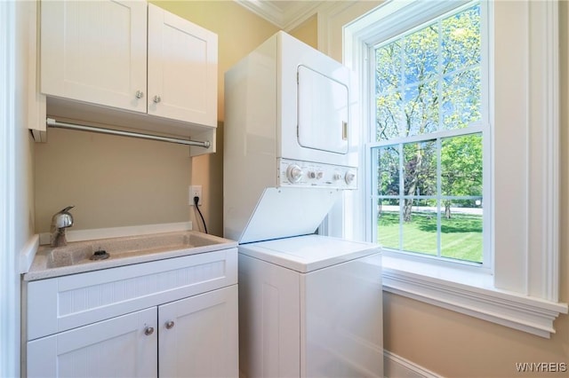 8785 Main St, Clarence, NY 14221 - laundry area featuring stacked washer and clothes dryer, cabinet space, and crown molding