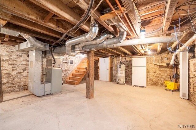 8785 Main St, Clarence, NY 14221 - unfinished below grade area featuring freestanding refrigerator, gas water heater, stairs, and heating unit