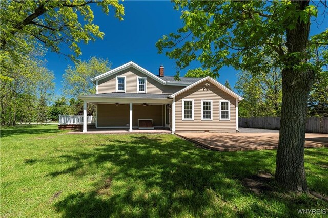 8785 Main St, Clarence, NY 14221 - rear view of property featuring ceiling fan, a chimney, and a patio area