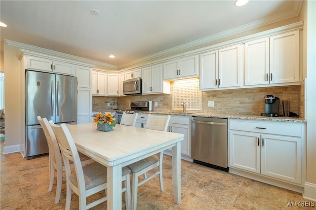 8785 Main St, Clarence, NY 14221 - kitchen with stainless steel appliances, decorative backsplash, ornamental molding, a sink, and light stone counters