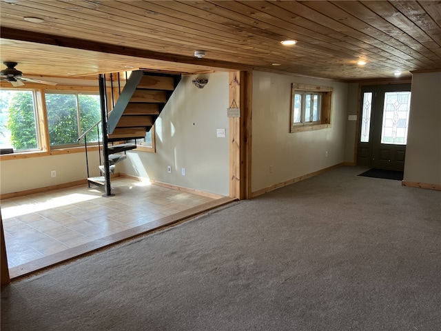 8976 Trio Dr, Urbana, NY 14840 - basement featuring wooden ceiling, stairway, ceiling fan, baseboards, and carpet floors