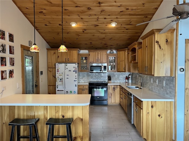 8976 Trio Dr, Urbana, NY 14840 - kitchen featuring stainless steel appliances, a sink, a peninsula, wood ceiling, and decorative backsplash