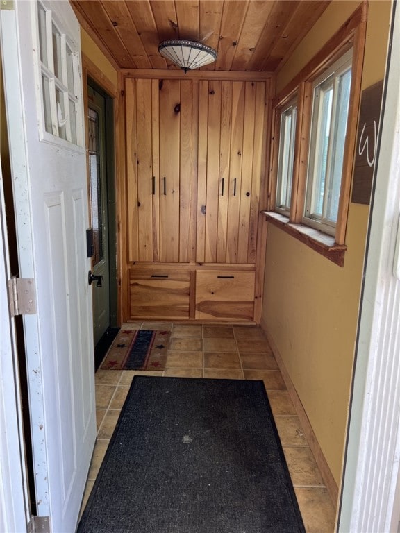 8976 Trio Dr, Urbana, NY 14840 - mudroom with wooden ceiling, light tile patterned flooring, and wooden walls