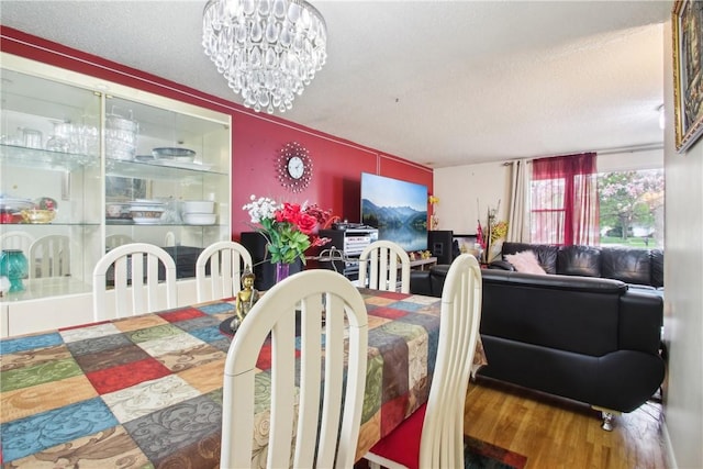 489 Bridgewood Dr, Greece, NY 14612 - dining area featuring wood finished floors, a textured ceiling, and a chandelier