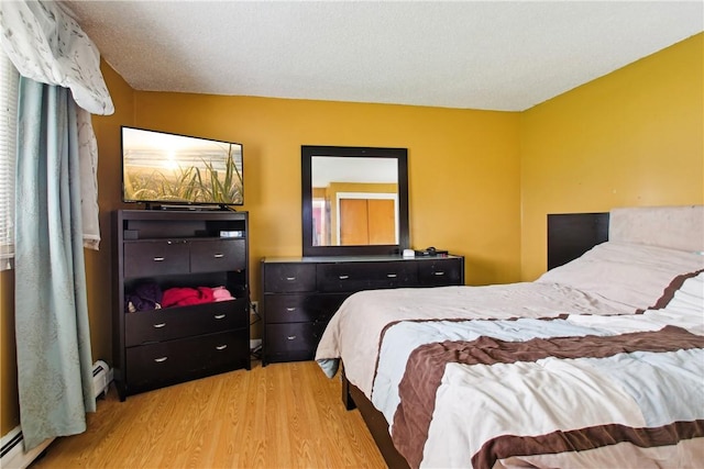 489 Bridgewood Dr, Greece, NY 14612 - bedroom featuring wood finished floors and a baseboard radiator