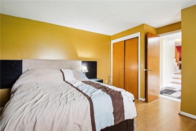 489 Bridgewood Dr, Greece, NY 14612 - bedroom with wood finished floors, a closet, and baseboards