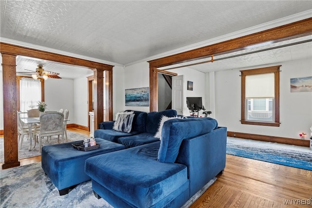 70 Seymour St, Tonawanda-City, NY 14150 - living room with baseboards, wood finished floors, decorative columns, a ceiling fan, and crown molding