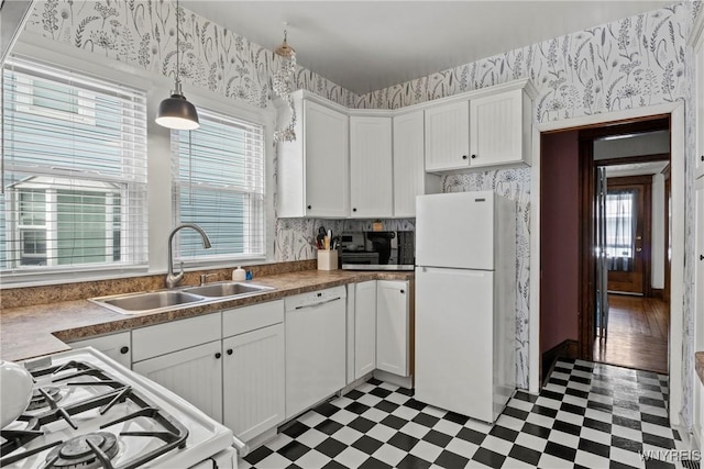 70 Seymour St, Tonawanda-City, NY 14150 - kitchen featuring white appliances, tile patterned floors, wallpapered walls, a sink, and healthy amount of natural light