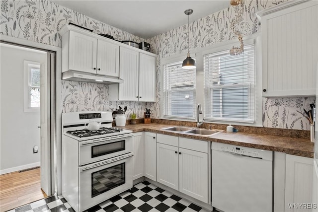 70 Seymour St, Tonawanda-City, NY 14150 - kitchen featuring white appliances, a sink, under cabinet range hood, wallpapered walls, and light floors