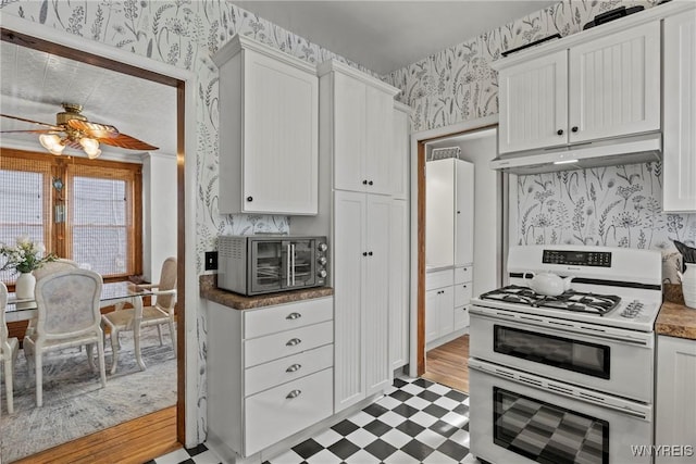 70 Seymour St, Tonawanda-City, NY 14150 - kitchen featuring double oven range, wallpapered walls, light floors, under cabinet range hood, and white cabinets