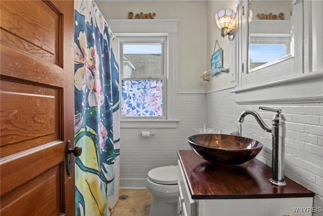 70 Seymour St, Tonawanda-City, NY 14150 - full bathroom with vanity, toilet, a wainscoted wall, and a shower with shower curtain