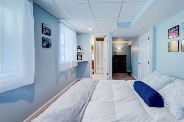 272 Shaftsbury Rd, Brighton, NY 14610 - bedroom with baseboards, a drop ceiling, and ensuite bath