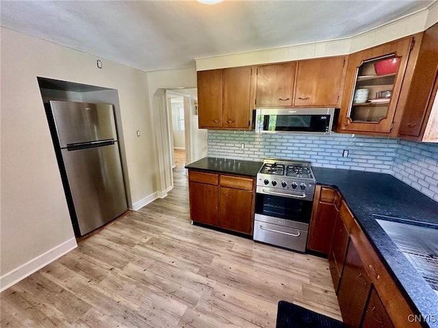 131 Hazelhurst Ave, Syracuse, NY 13206 - kitchen with stainless steel appliances, dark countertops, and brown cabinetry