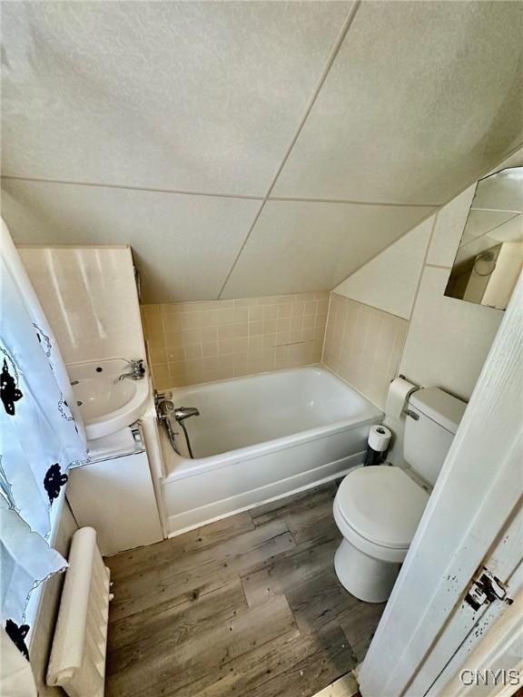 131 Hazelhurst Ave, Syracuse, NY 13206 - bathroom featuring toilet, wood finished floors, a tub, and a shower