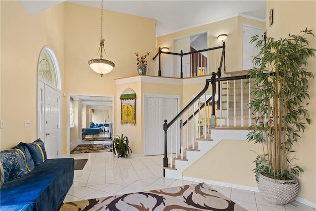 23 Sunberry Dr, Perinton, NY 14526 - entrance foyer with stairway, baseboards, tile patterned floors, a high ceiling, and crown molding