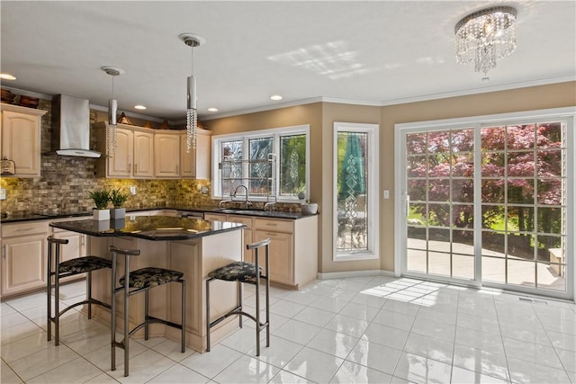 23 Sunberry Dr, Perinton, NY 14526 - kitchen featuring wall chimney range hood, a sink, a kitchen bar, backsplash, and crown molding