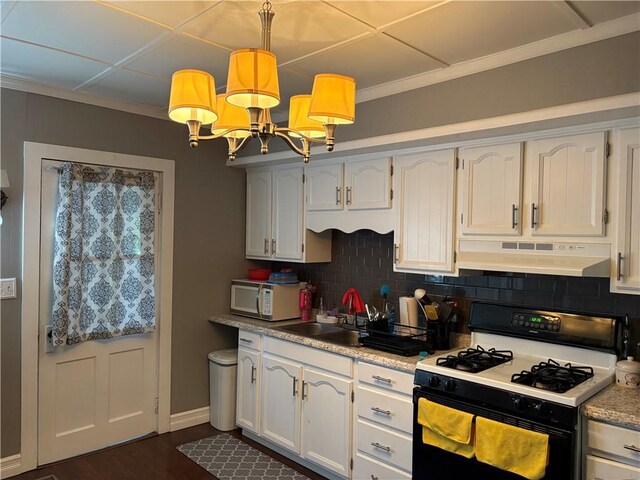 115 12th St, Dix, NY 14891 - kitchen featuring range with gas cooktop, under cabinet range hood, white microwave, backsplash, and crown molding