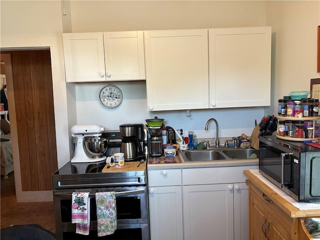115 12th St, Dix, NY 14891 - kitchen featuring black microwave, a sink, white cabinetry, light countertops, and double oven range