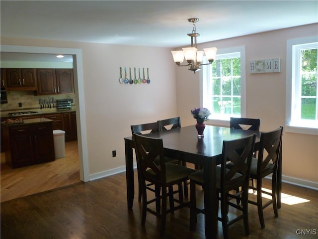 3899 Sweet Rd, Pompey, NY 13078 - dining area featuring healthy amount of natural light, a chandelier, and dark wood-style flooring