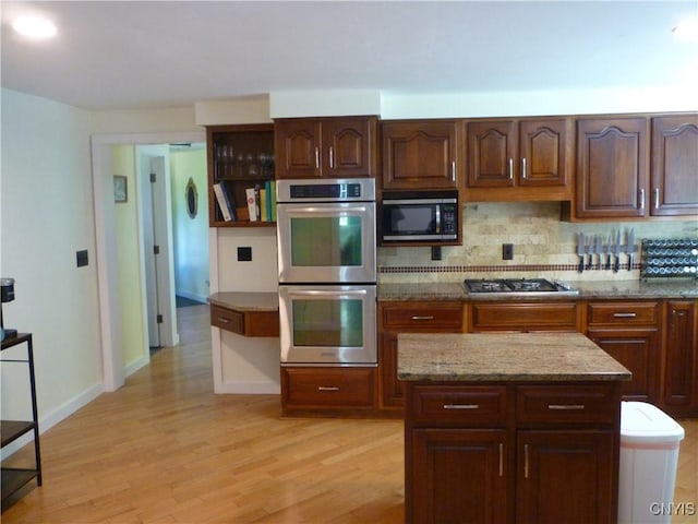 3899 Sweet Rd, Pompey, NY 13078 - kitchen featuring appliances with stainless steel finishes, light wood-style floors, backsplash, light stone counters, and open shelves