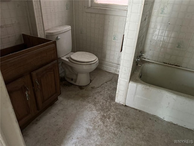 1867 Pierce Ave, Niagara Falls, NY 14301 - bathroom with toilet, tile walls, vanity, and shower / bath combination