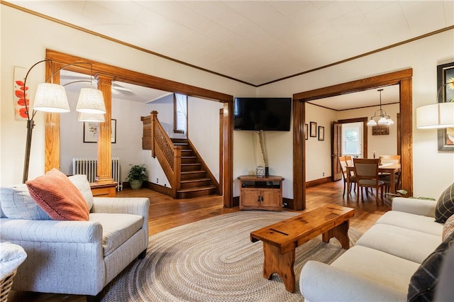 110 Lansdale St, Rochester, NY 14620 - living area featuring radiator, ornamental molding, wood finished floors, stairway, and baseboards