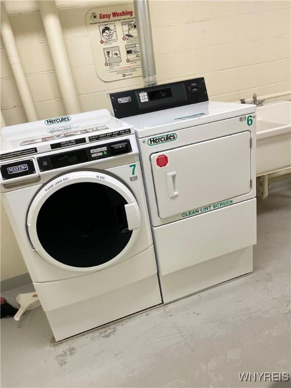 151 Buffalo Ave Unit 404, Niagara Falls, NY 14303 - washroom featuring independent washer and dryer and concrete block wall