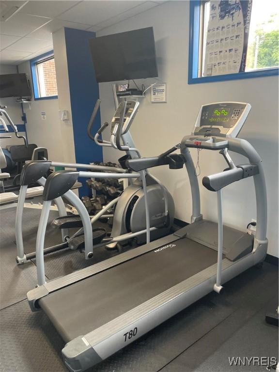 151 Buffalo Ave Unit 404, Niagara Falls, NY 14303 - workout area featuring a paneled ceiling and baseboards