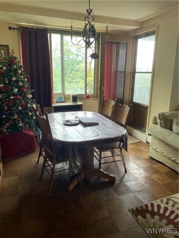 151 Buffalo Ave Unit 404, Niagara Falls, NY 14303 - dining area featuring a chandelier and plenty of natural light