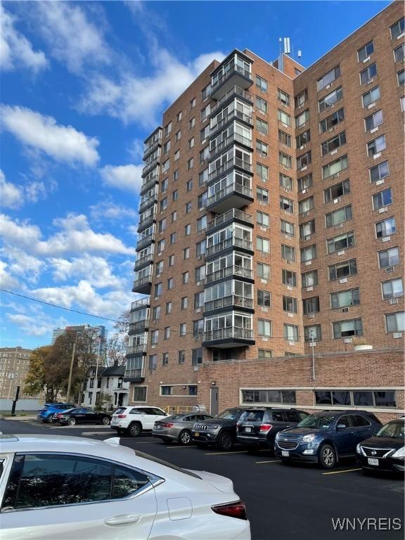 151 Buffalo Ave Unit 404, Niagara Falls, NY 14303 - view of apartment building / complex featuring uncovered parking