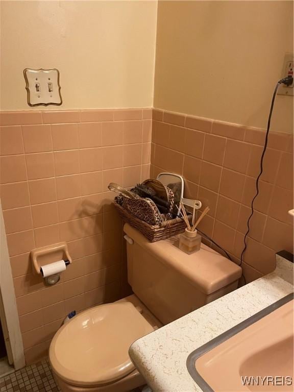 151 Buffalo Ave Unit 404, Niagara Falls, NY 14303 - bathroom with tile walls, wainscoting, vanity, and tile patterned floors