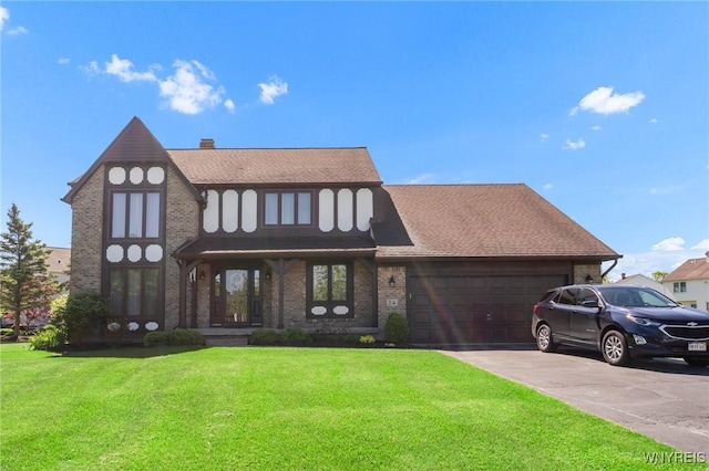 24 Bluejay Cir, Lancaster, NY 14086 - view of front facade with brick siding, a front lawn, and a garage