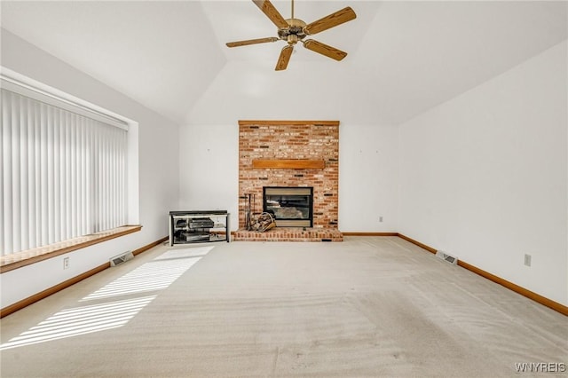 24 Bluejay Cir, Lancaster, NY 14086 - unfurnished living room with vaulted ceiling, a ceiling fan, carpet flooring, a brick fireplace, and baseboards